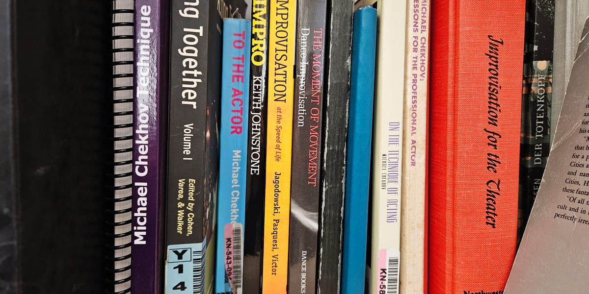Photo of bookshelf showing spines of books on acting and improvisation.